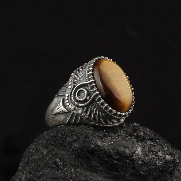 this image contains a tigers eye ring with egyptian crown