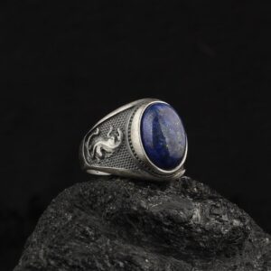 Leopard Ring is a statement ring with a lapis lazuli gemstone on top it and leopard ornaments at his band