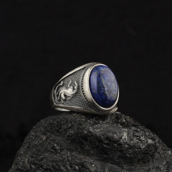 leopard ring is a statement ring with a lapis lazuli gemstone on top it and leopard ornaments at his band
