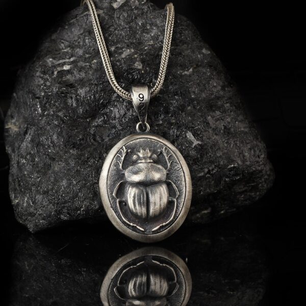 scarab medallion is a round sterling silver jewelry piece.