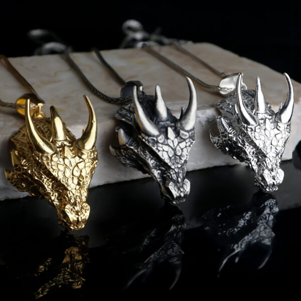 three smaug necklaces. one of the polished, the other gold plated and the last one oxidized