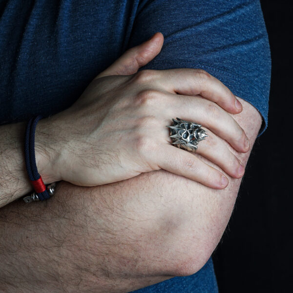 a man wearing king of the dead army ring