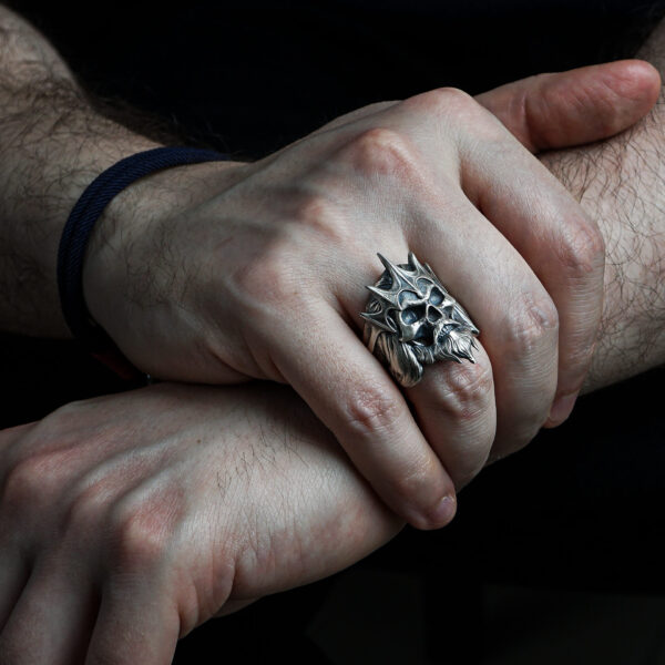 a man wearing king of the dead army ring