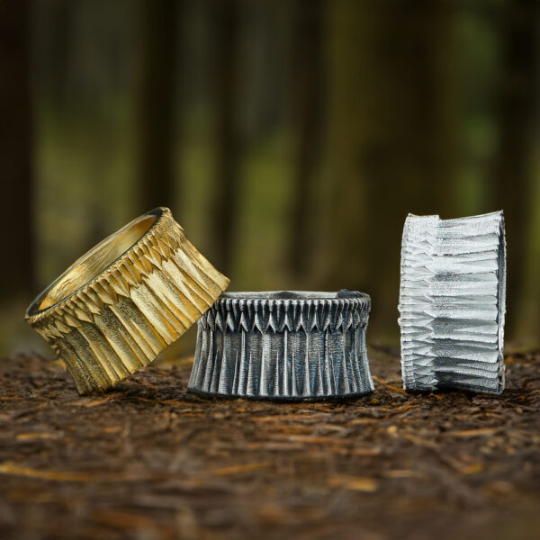 three black gates of mordor ring. one of them is gold plated, the other one is polished and the last one is oxidized.